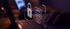 A person types on a laptop keyboard with a graphic of a padlock and a login form, symbolizing online security and data protection—highlighting the need to avoid security risks when considering security outsourcing solutions.